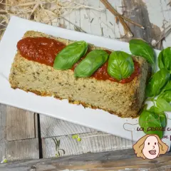 Un délicieux flan de courgettes, garni de sauce tomate et de feuilles de basilic frais, prêt à être dégusté.
