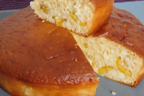 Un gâteau vosgien aux mirabelles, doré et moelleux, avec des morceaux de fruits jaunes visibles à l'intérieur.