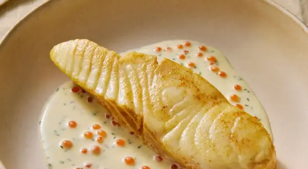 Un flétan poêlé, nappé d'une sauce crémeuse aux œufs de poisson, une flétan recette gastronomique d'exception.