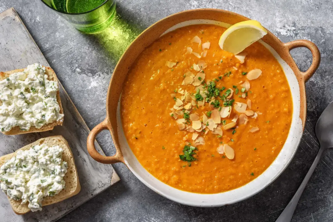 Soupe égyptienne onctueuse, garnie d'amandes effilées et de persil frais, avec une tranche de citron. Accompagnée de toasts au fromage frais.