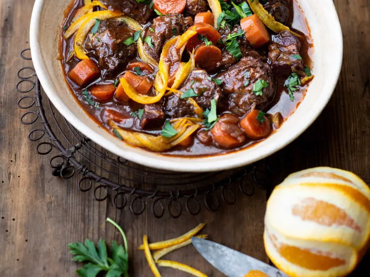 Un plat mijoté de bœuf aux carottes et oignons, parfumé à l'orange, parfait pour une recette du patia réconfortante.
