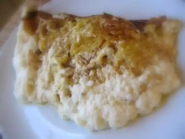 Une omelette normande dorée, moelleuse et savoureuse, servie sur une assiette blanche.
